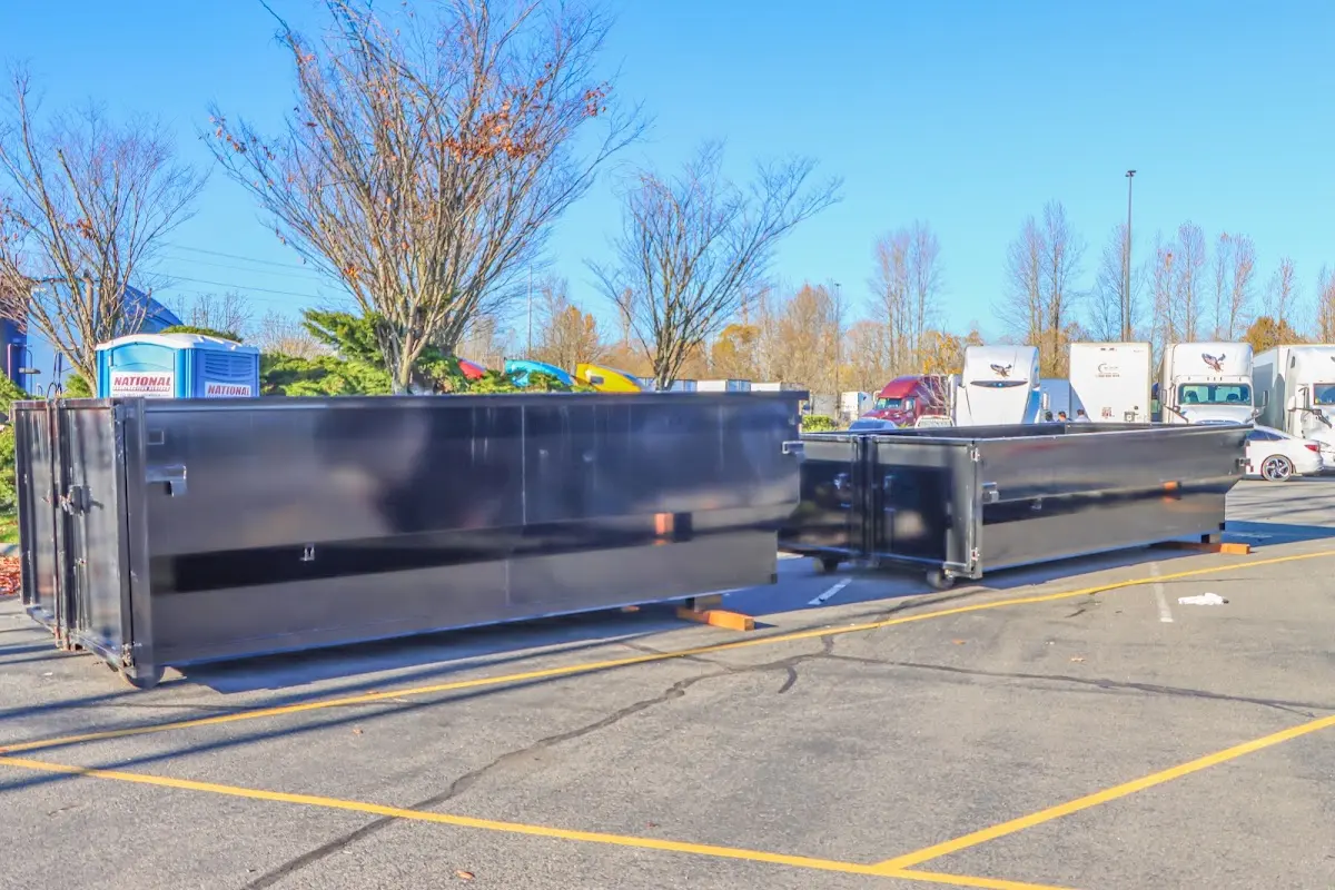 Professional dumpster rental service with roll-off container on residential driveway in Aptos